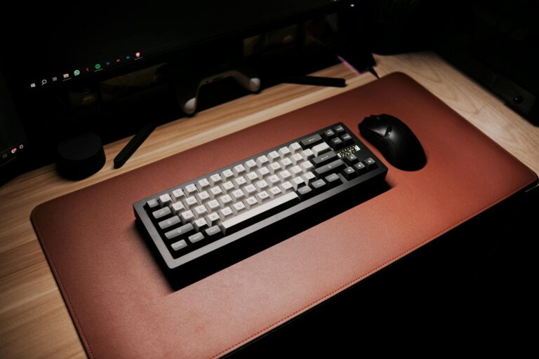 Stylish computer desk featuring a sleek mechanical keyboard and mouse on a brown mat.